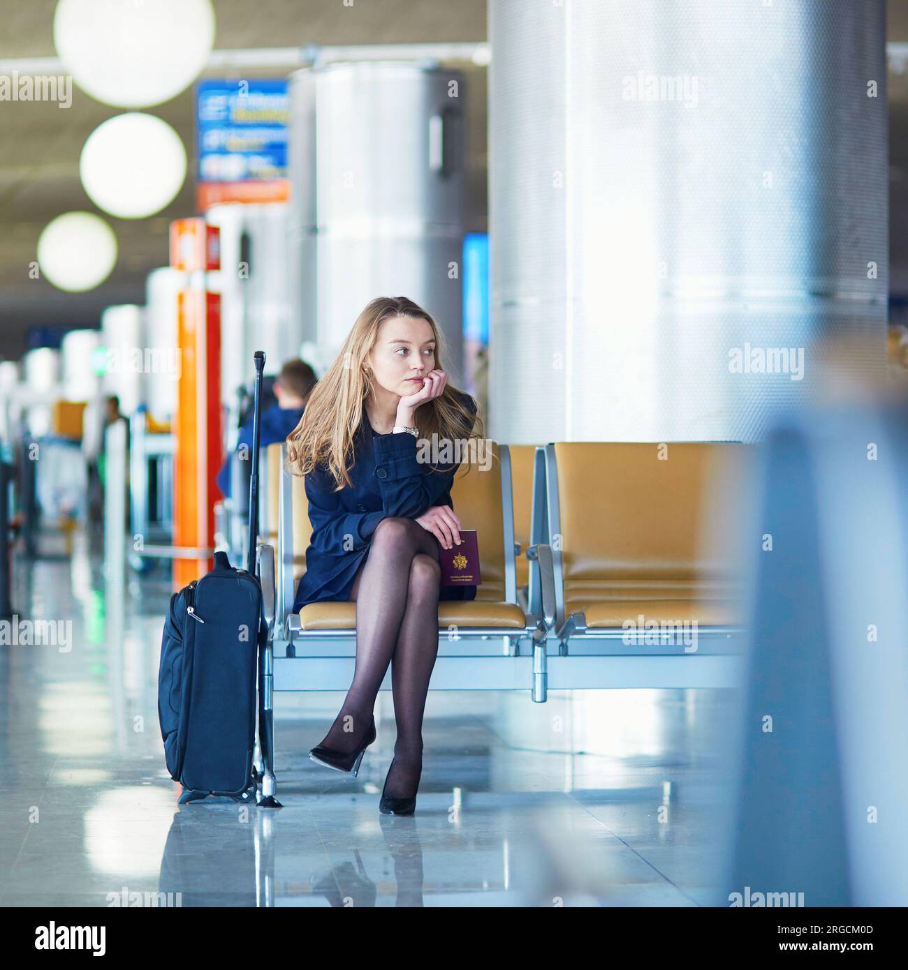 Young woman in international airport waiting for her flight Stock Photo ...