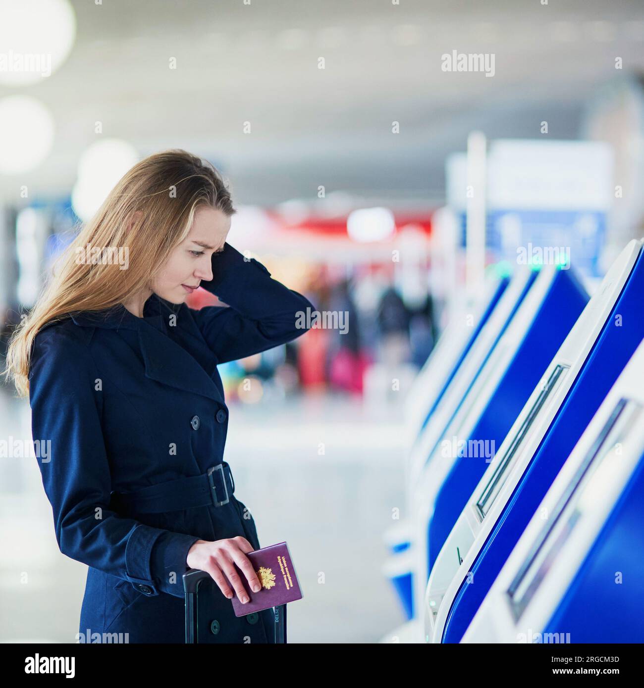 Young woman in international airport doing self check-in Stock Photo ...