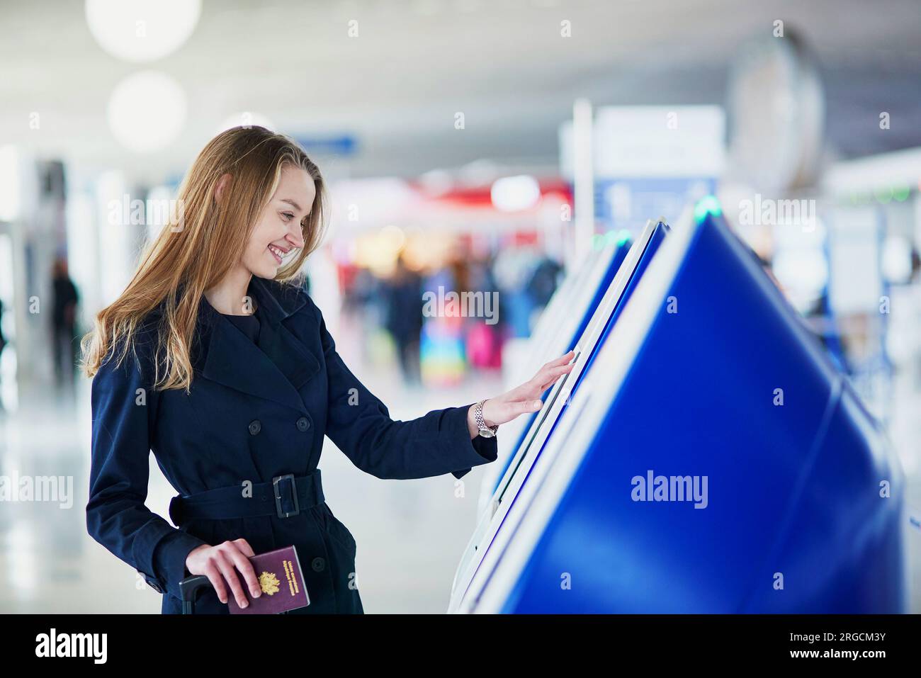 Young woman in international airport doing self check-in Stock Photo ...