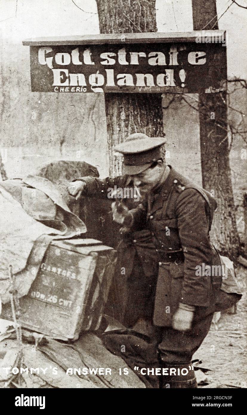 British soldier in former German area of the Western Front, WW1 - the German sign says 'God punish England', to which Tommy's answer is 'Cheerio' Stock Photo
