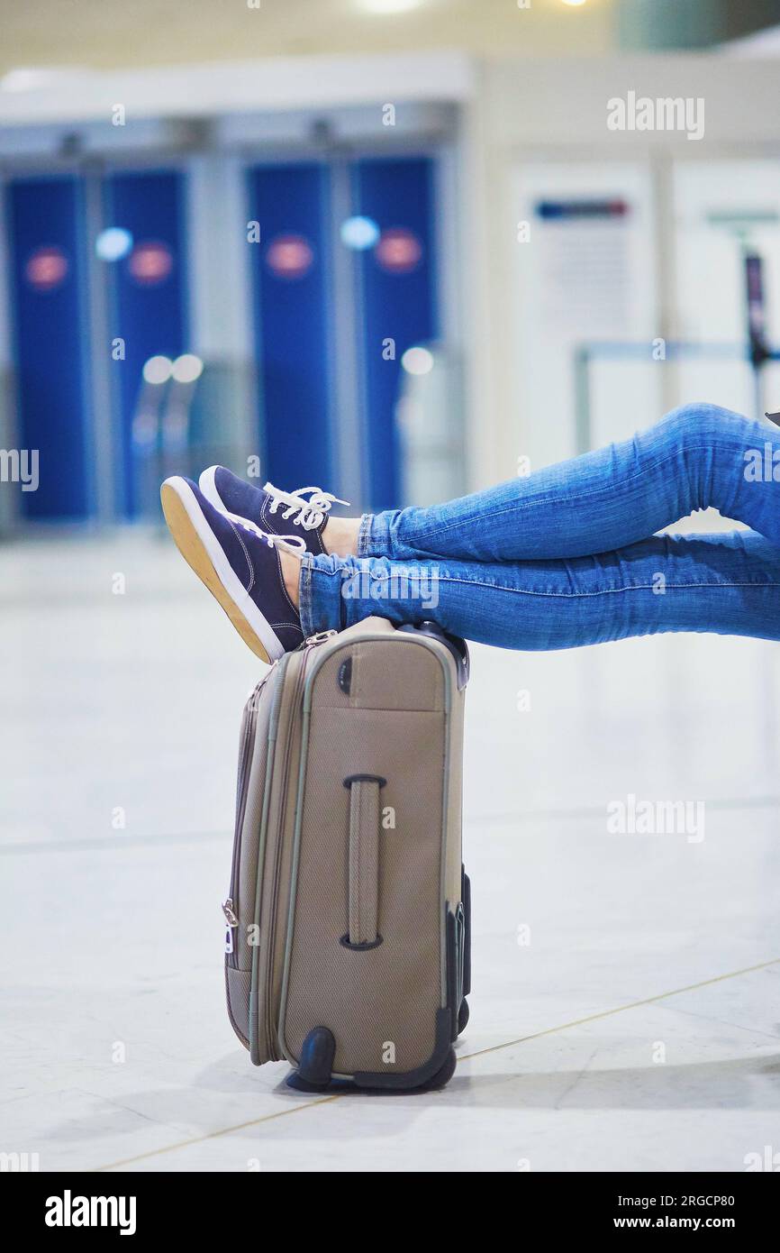 Young woman in international airport waiting for her flight Stock Photo ...