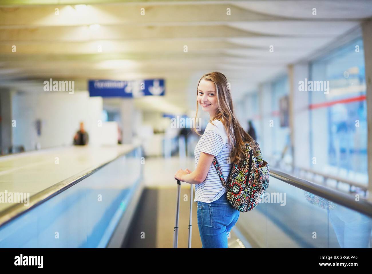 Young woman in international airport on travelator Stock Photo - Alamy