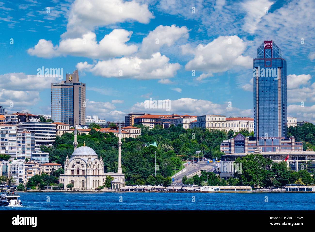 Istanbul, Turkey, Türkiye. Dolmabahce Mosque on Bosphorus Waterfront.  Ritz Carlton Hotel in background. Suzer Plaza on right. Beyoglu District. Stock Photo