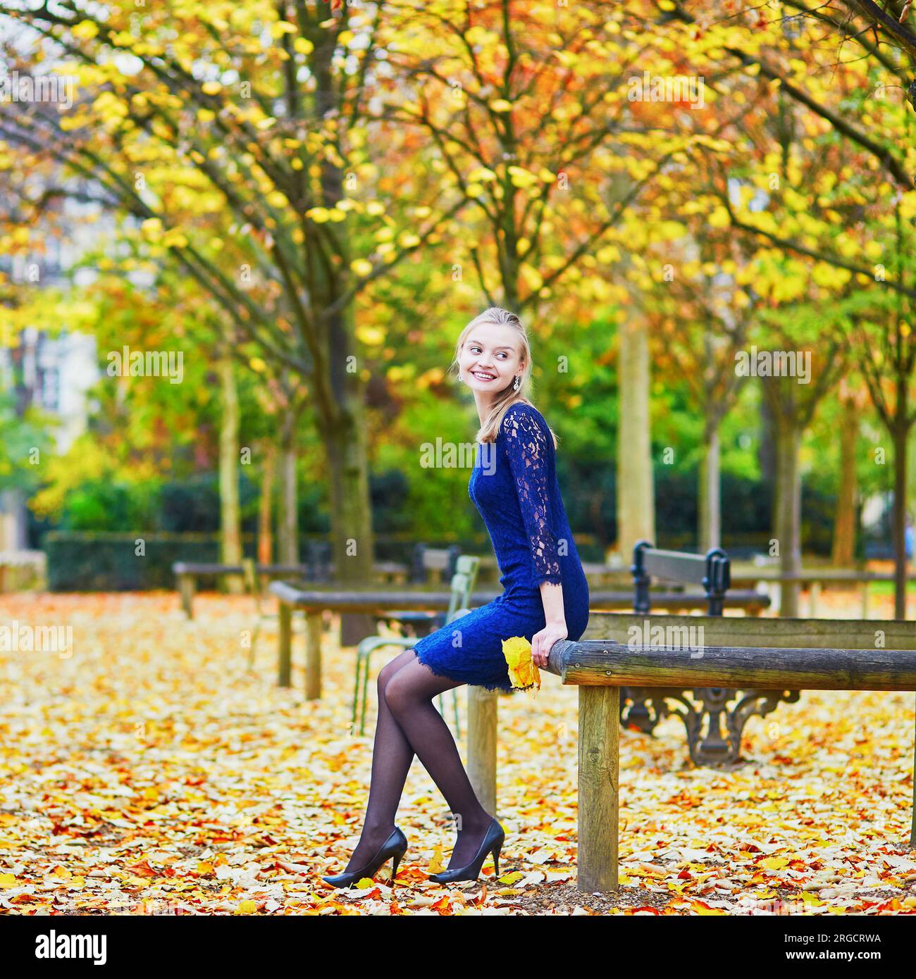 Beautiful young woman in blue dress in the Luxembourg garden of Paris on a  fall day Stock Photo - Alamy