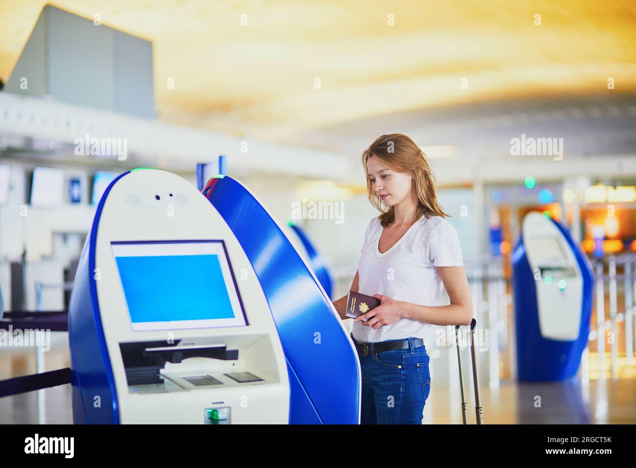 Young woman in international airport doing self check-in Stock Photo ...