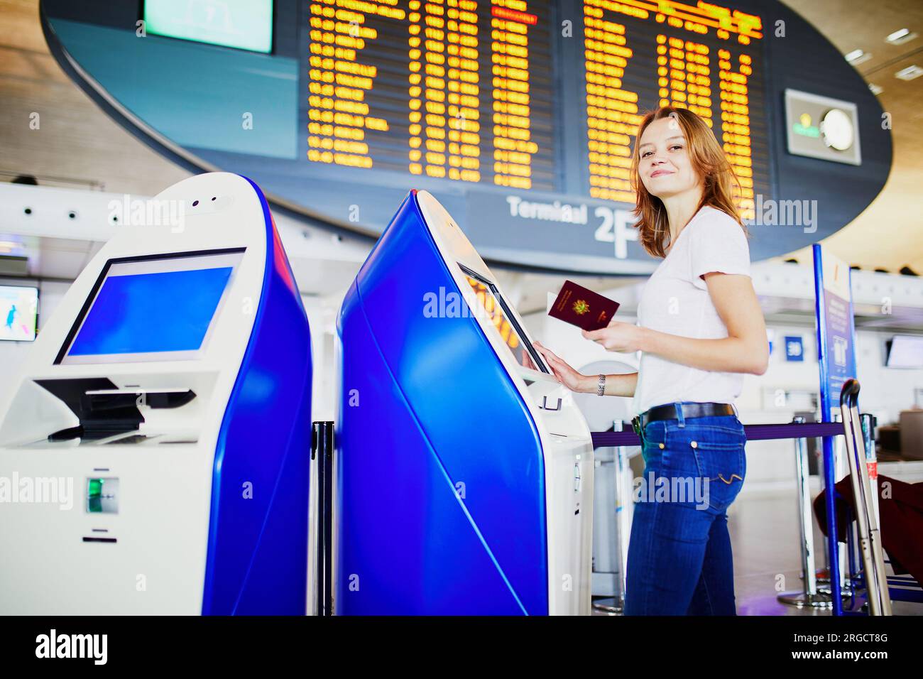Young woman in international airport doing self check-in Stock Photo ...
