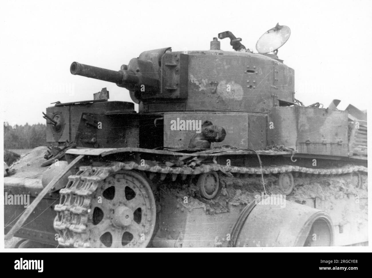 A Soviet T-28 multi-turreted medium tank, knocked out, with dead crew ...