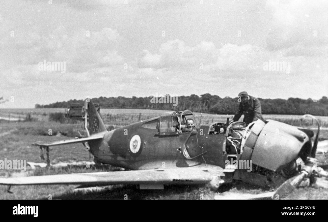 A crashed Curtiss H75 C.1, being inspected by German forces. (The Curtiss H75 C.1, had the Curtiss designation Hawk 75A-1 and was roughly equivalent to the P-36A Mohawk, but with equipment differences). Stock Photo