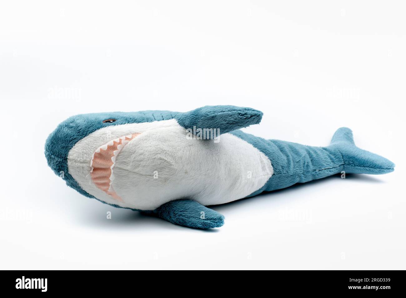 Nova Bana, Slovakia - August, 7, 2023 : Blahaj, Ikea plush toy made of recycled polyester. Stuffed Animal Toy Blue shark on white background. Stock Photo