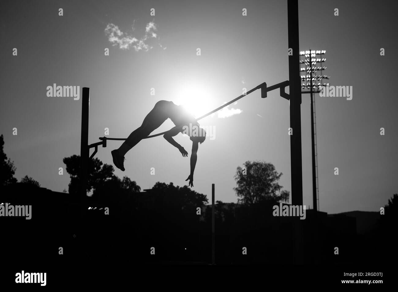Soaring Heights: Capturing the Elegance of a Pole Vault Silhouette. Stock Photo