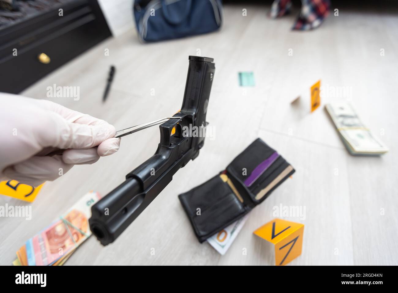 Detective in gloves looking evidence, crime scene Stock Photo Alamy