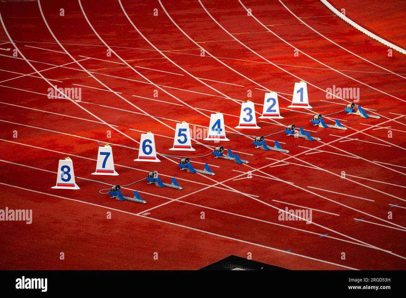 Start of sprint race. Numbers and starting blocks on the red track