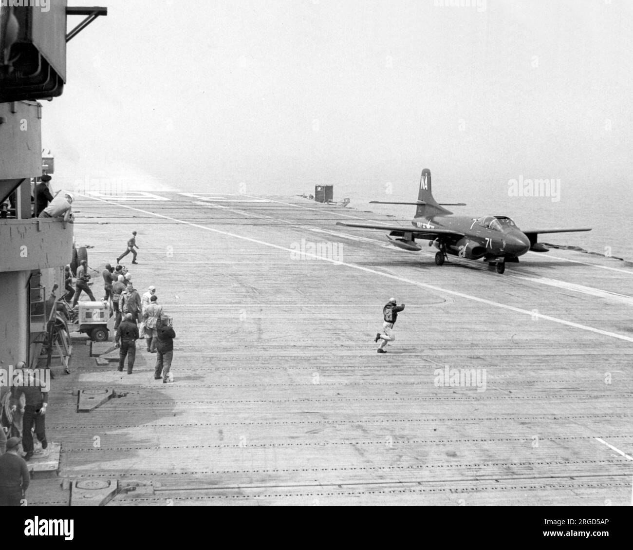 United States Navy - Douglas F3D-2 Skyknight performing touch and goes on the newly installed 'Angled Deck' of USS Antietam CVA-36. (Note:- the F3D was not fitted with ejection seats, hence the canopy hatch being open for launch and recovery to facilitate escape, if needed), Stock Photo