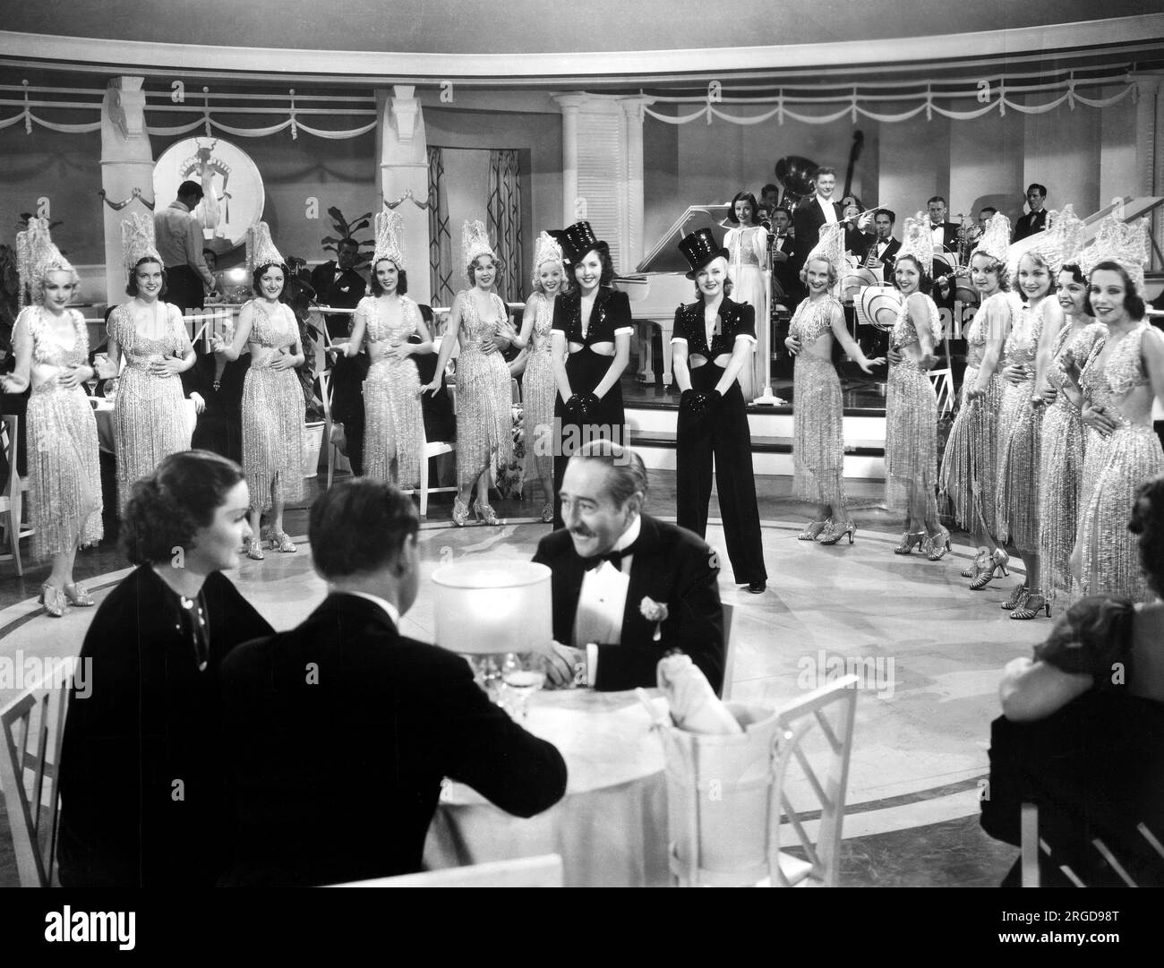 Gail Patrick, Franklin Pangborn, Philip Menjou (all seated at table), Ann Miller, Ginger Rogers (both on-stage in black top hats), on-set of the Film, 'Stage Door', RKO Radio Pictures, 1937 Stock Photo