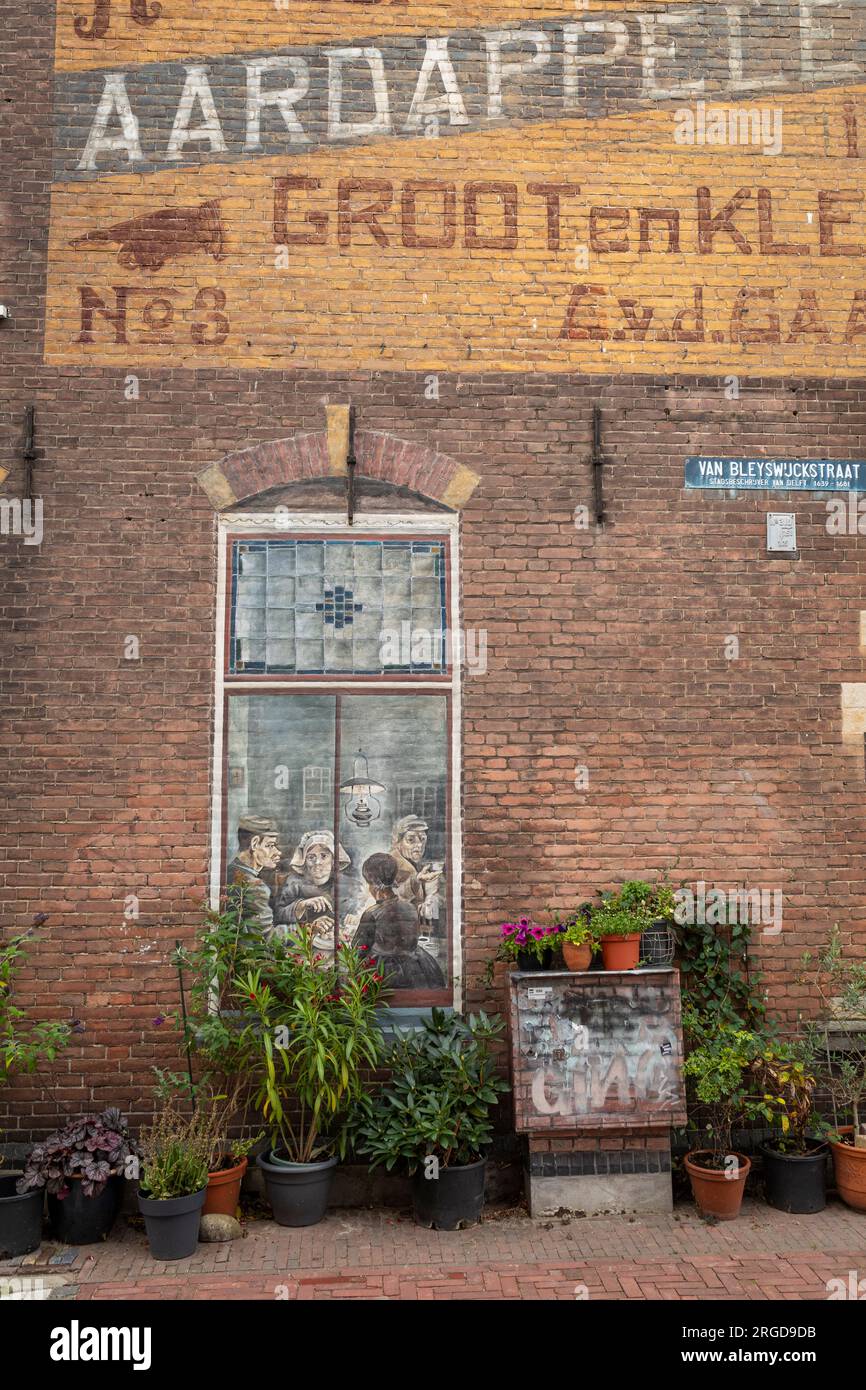 House (former potato trade) with a copy mural of the potato eaters by Vincent van Gogh, Delft, Netherlands Stock Photo