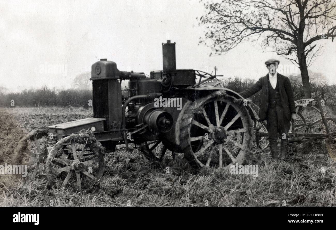 Farmer with a Ransome plough pulled by a lightweight steam engine (possibly stuck in the mud awaiting a larger and more suitable vehicle to tow him out!). Stock Photo