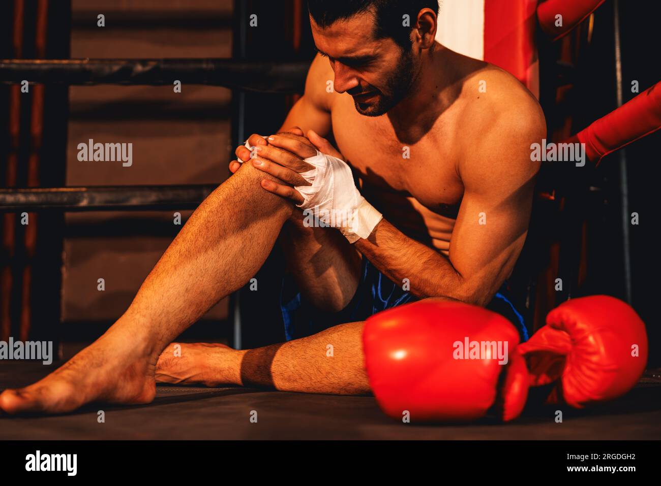 Caucasian boxer with pain and injury after intense boxing training or  fighting match, sitting at the edge of ring. Physical injury in sport  concept Stock Photo - Alamy