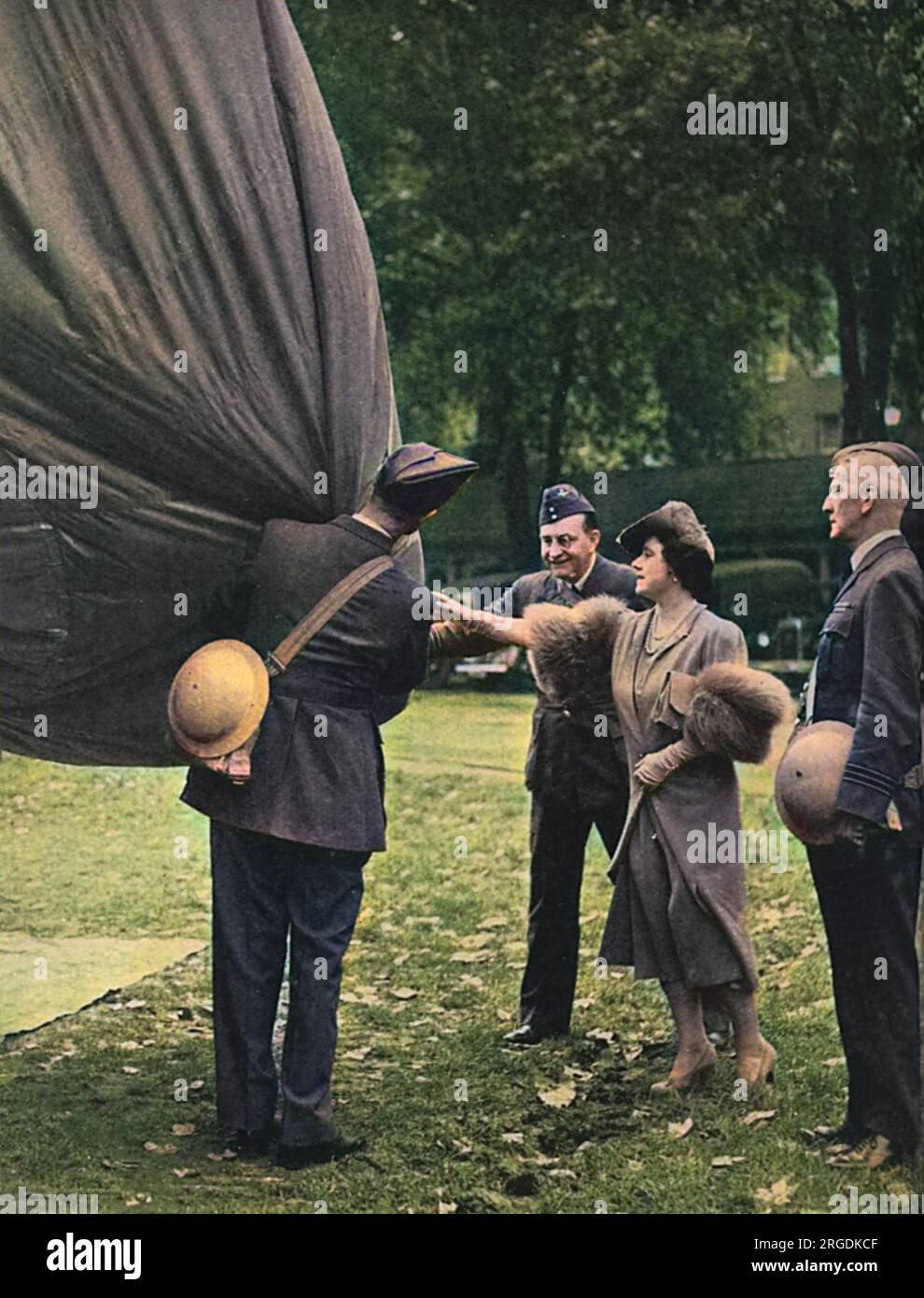 Queen Elizabeth (later the Queen Mother), inspects the fabric used on a barrage balloon as she and the King tour a balloon unit in October 1939. Stock Photo