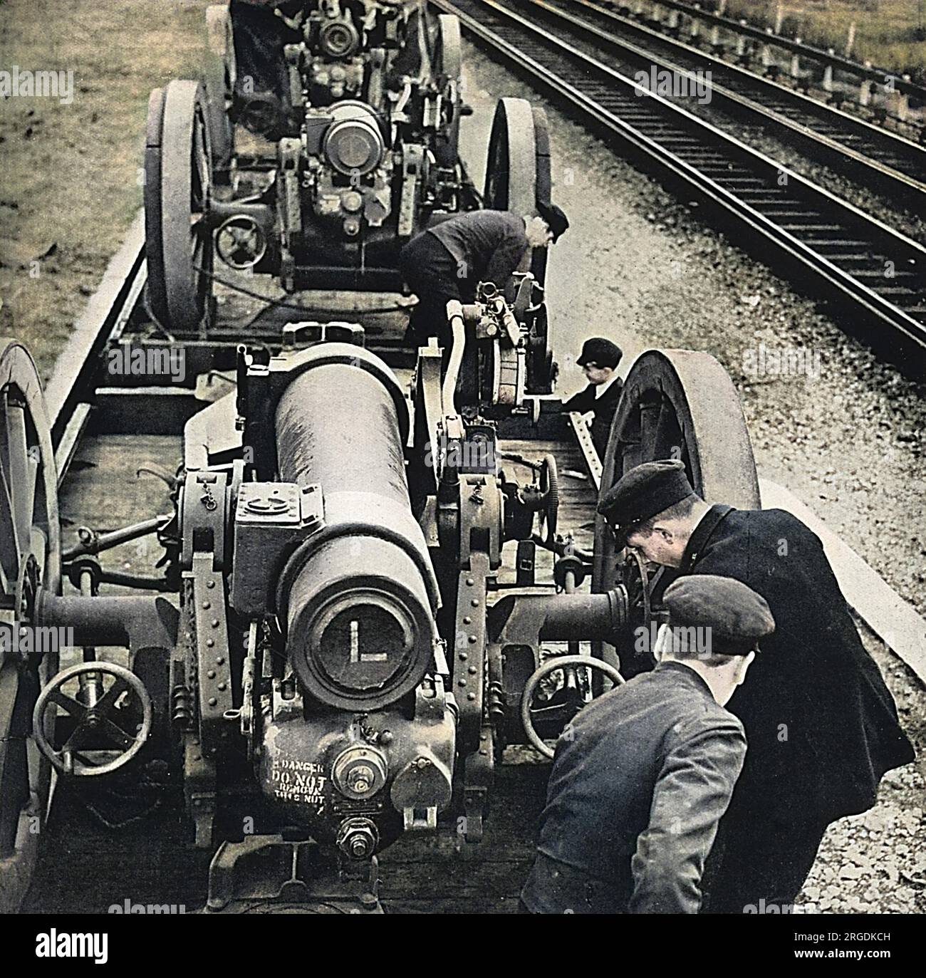 Station porters at a small country station at an undisclosed location in Britain, unloading heavy calibre howitzers from railway trucks. Stock Photo