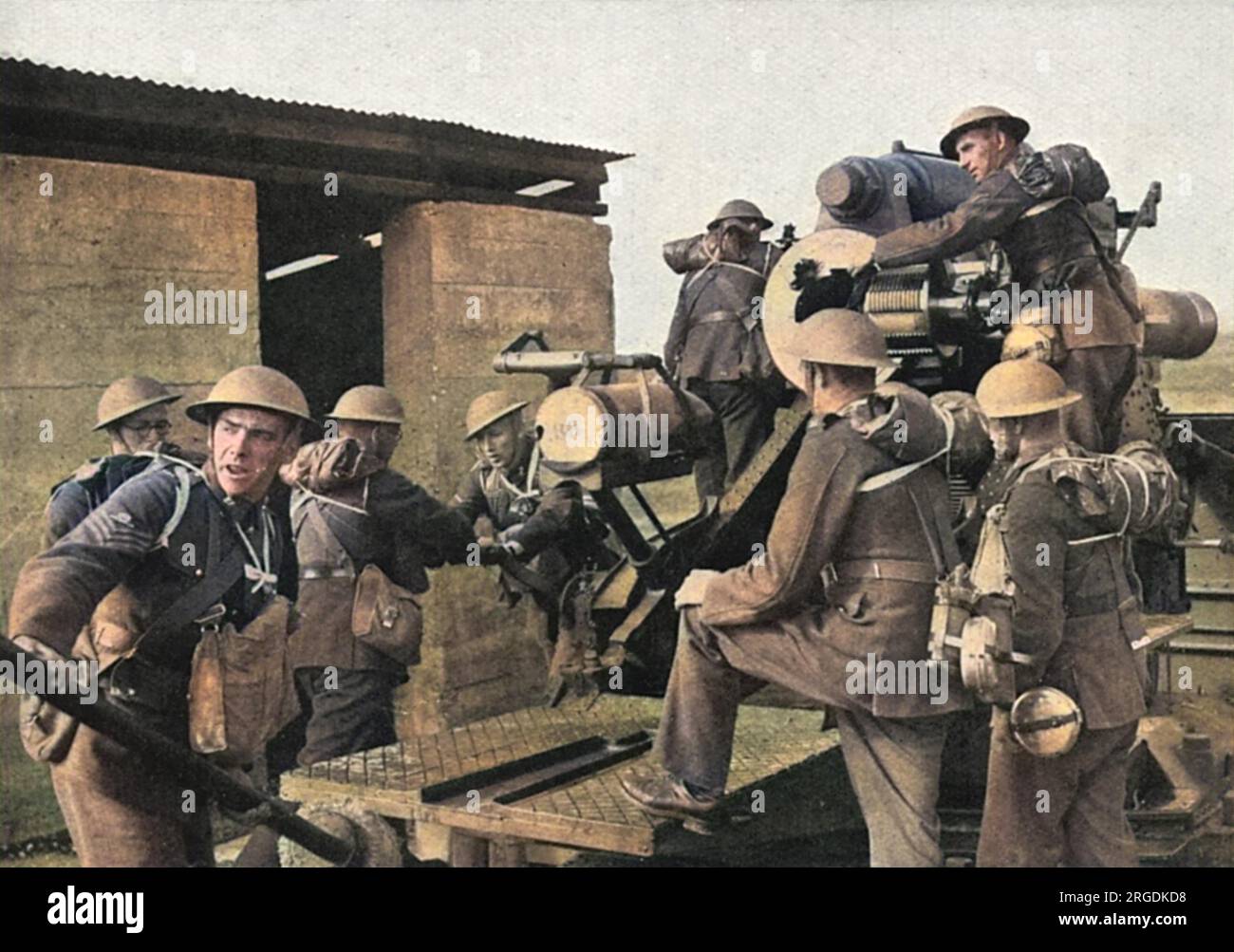 Scene at 'a famous Army school of Artillery' in Britain showing some of the latest and heaviest guns in action with men being trained to use them.  A large crew can be seen operating a 9.2 howitzer gun, with each man to his allotted post. Stock Photo
