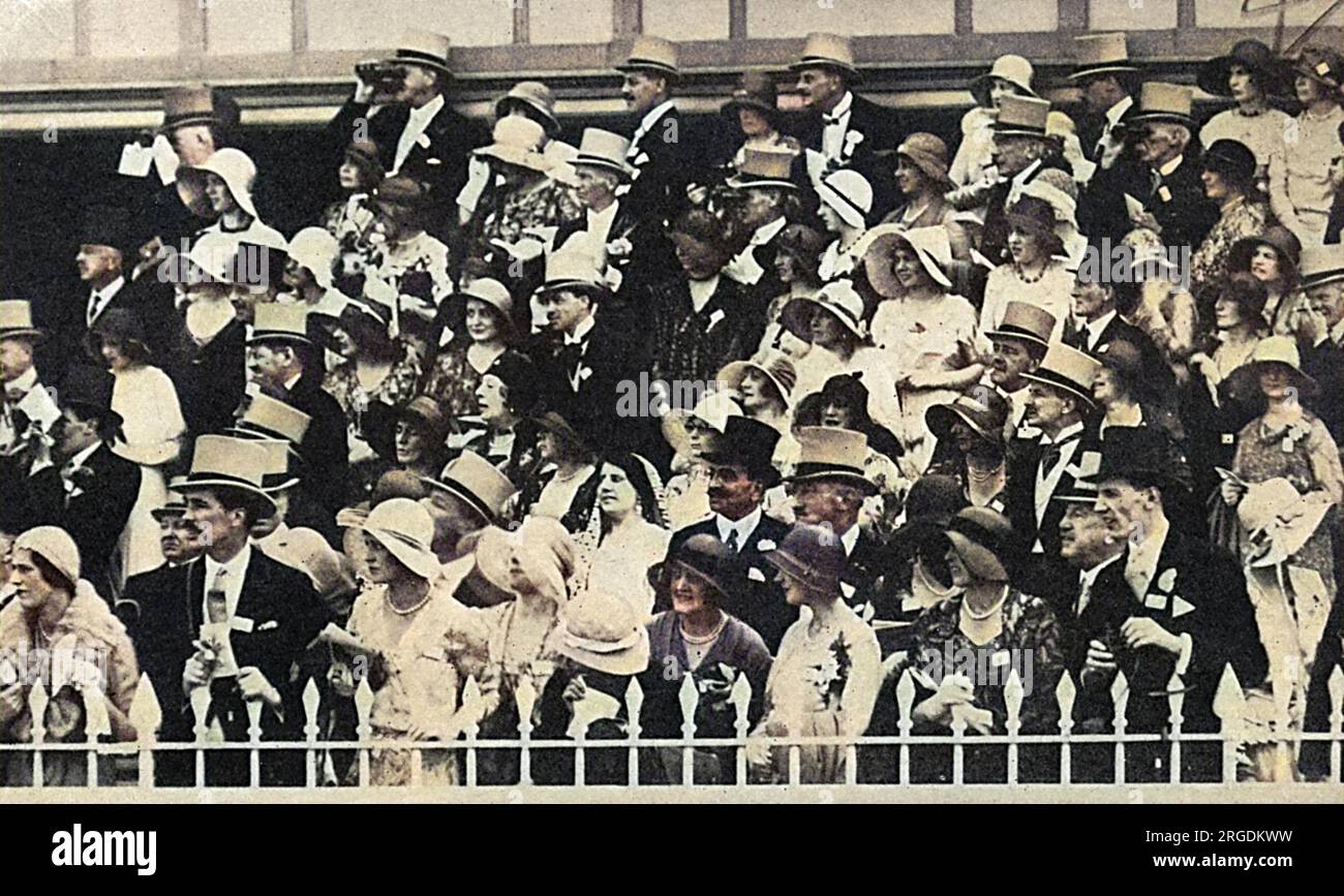 Smart society in the members' enclosure at Royal Ascot in June 1930, watching one of the ten races in the programme with interest. Stock Photo