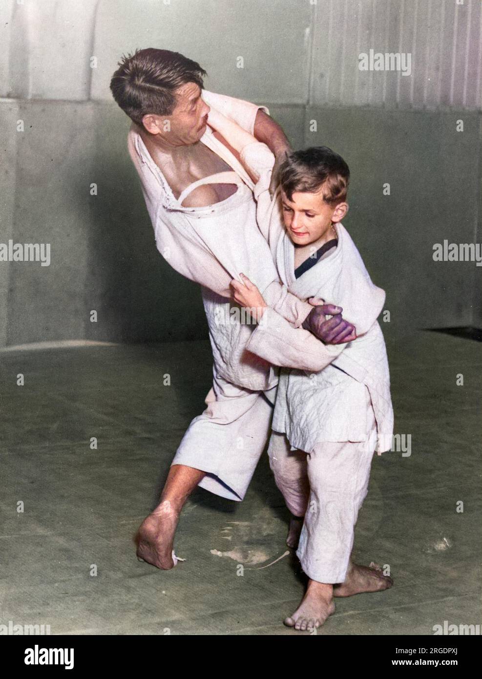 Mr. G. Koizumi, the Japanese expert, giving a JUJITSU lesson to young Master Andrew Eills! Stock Photo