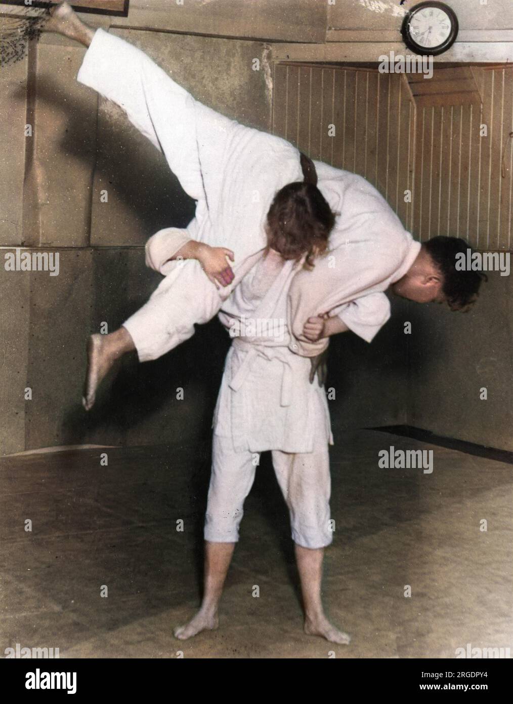 Mr. G. Koizumi, the Japanese expert, giving a JUJITSU lesson to female motorists to enable them to deal with bandits. Here a girl does a 'shoulder of veal' throw! Stock Photo