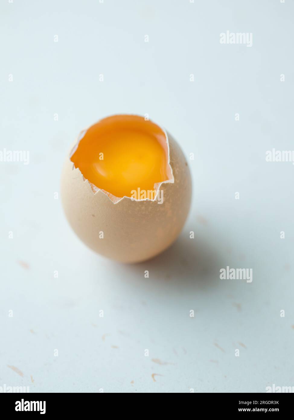 Cracked egg on white Stock Photo