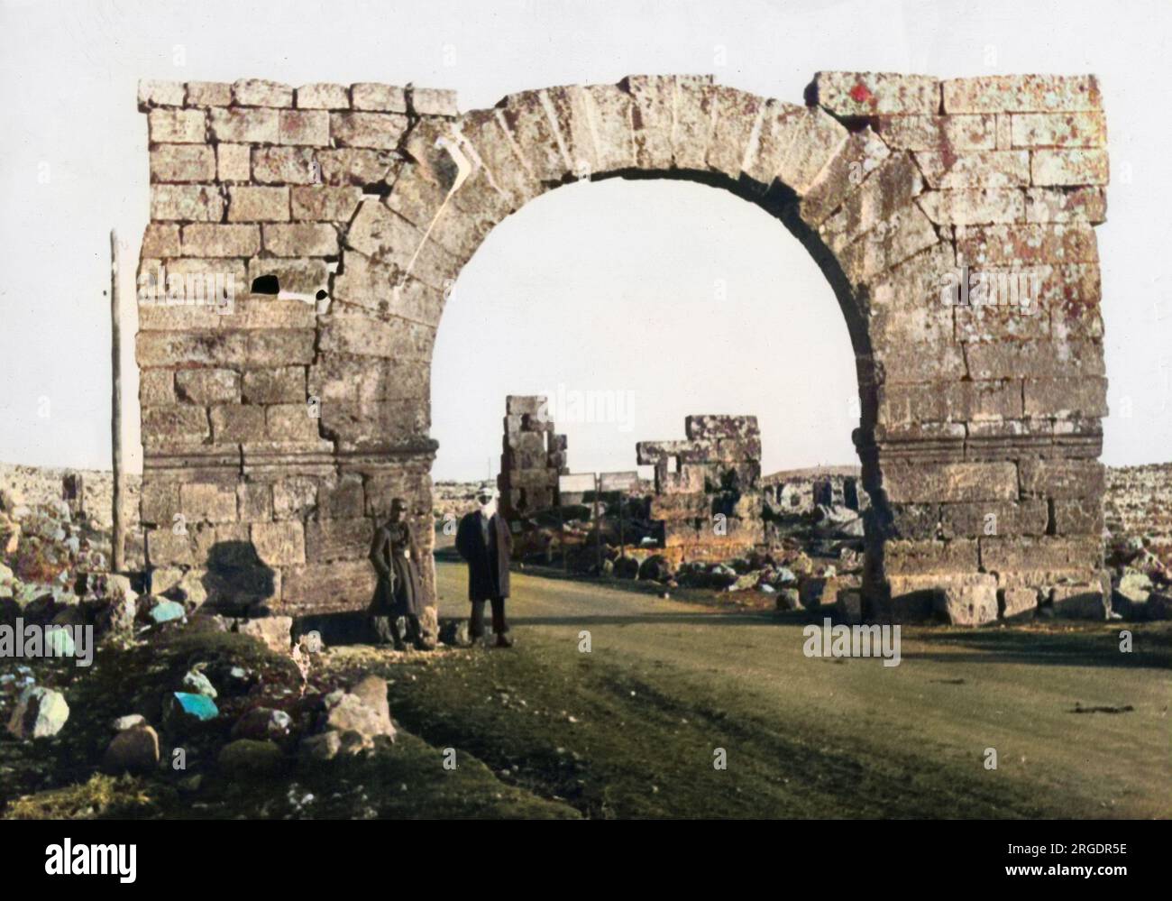 The Guard on the Roman Arch. Between Aleppo and Homs, Syria, this well-preserved stone arch stands in a field of ruins. Stock Photo