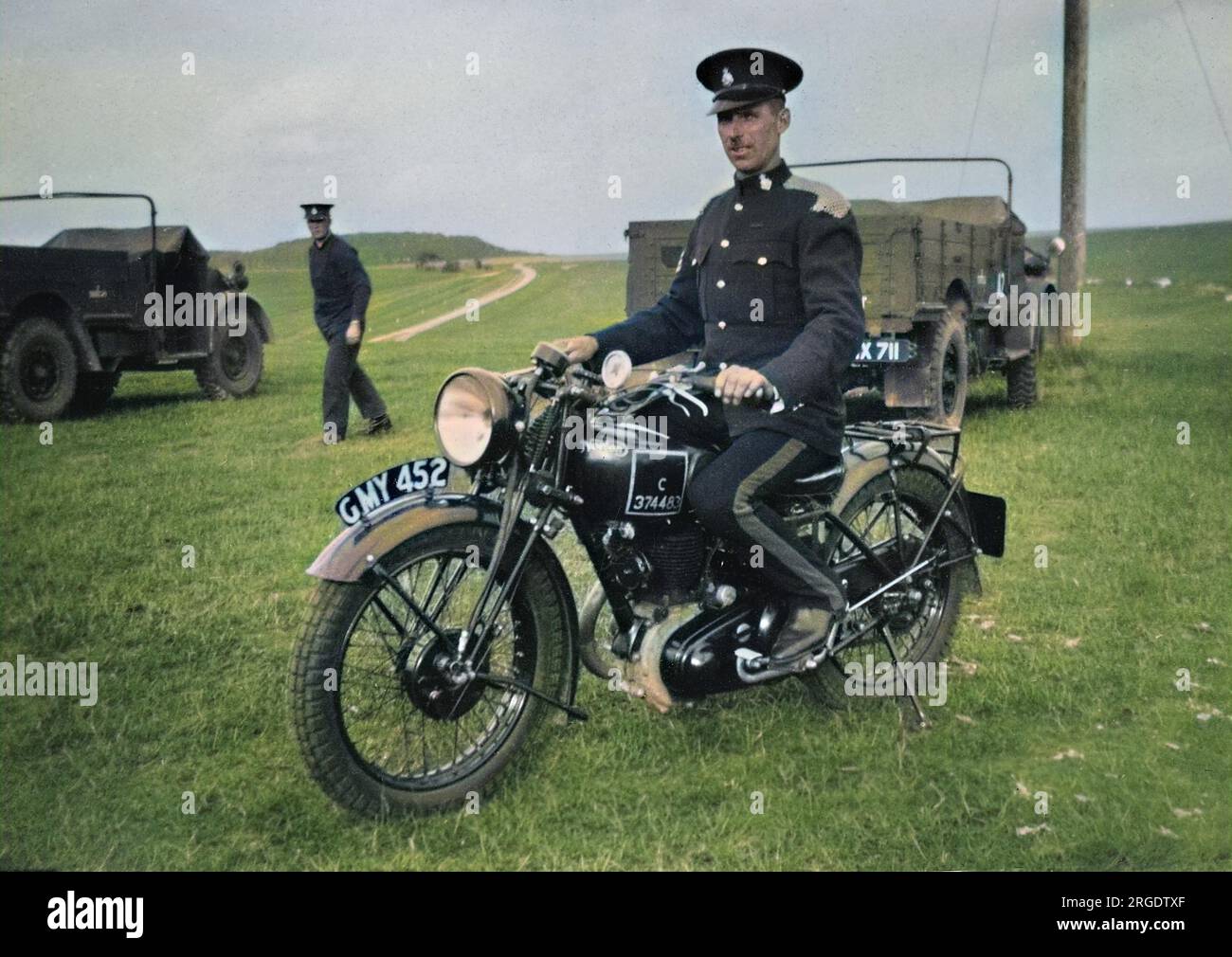 Soldier in dress uniform on a motorbike in a field near Okehampton, Devon. Stock Photo