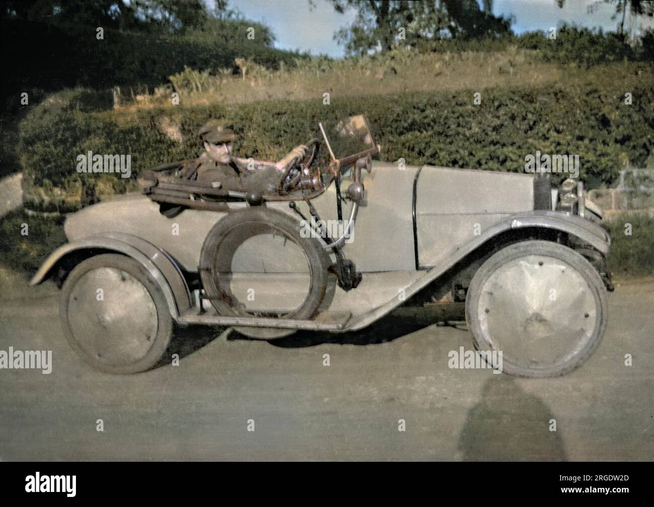 A man in military uniform driving a sports car. Stock Photo