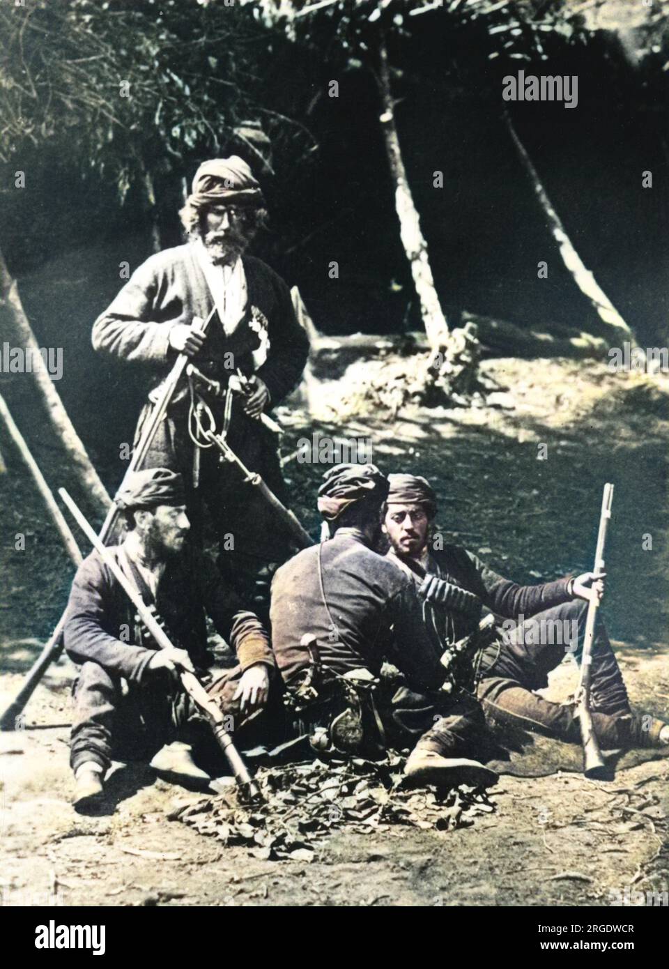 Four Russian heavily armed and bearded guides relaxing in a camp during the Russo-Turkish war (April 24, 1877 û March 3, 1878). Stock Photo