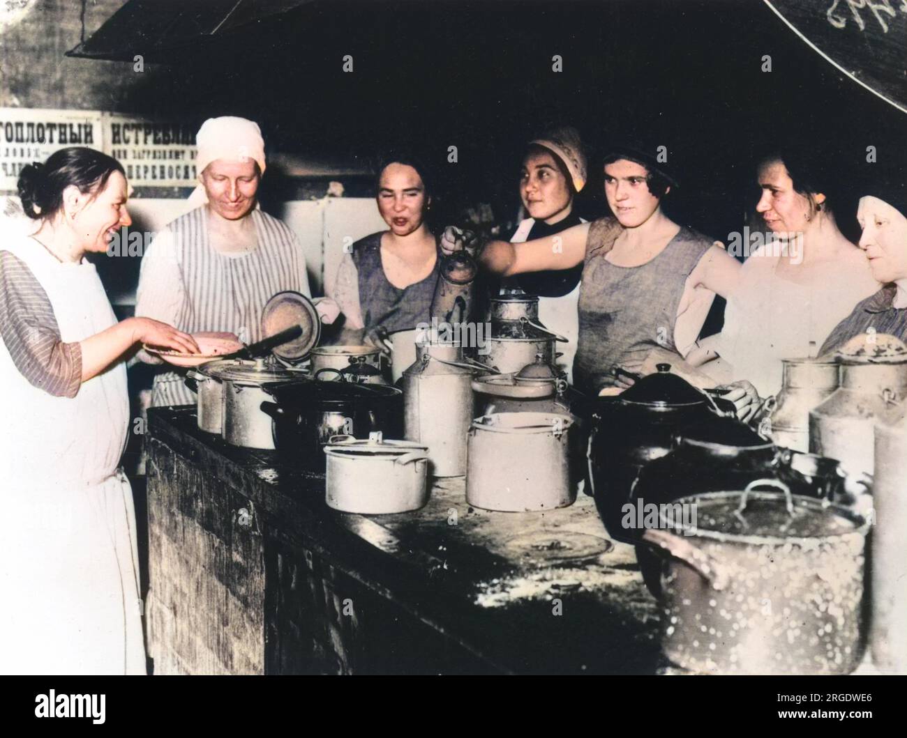 https://c8.alamy.com/comp/2RGDWE6/seven-women-busying-themselves-around-a-stone-work-top-adorned-with-an-array-of-large-tins-and-pots-in-a-1920s-russian-communal-kitchen-2RGDWE6.jpg