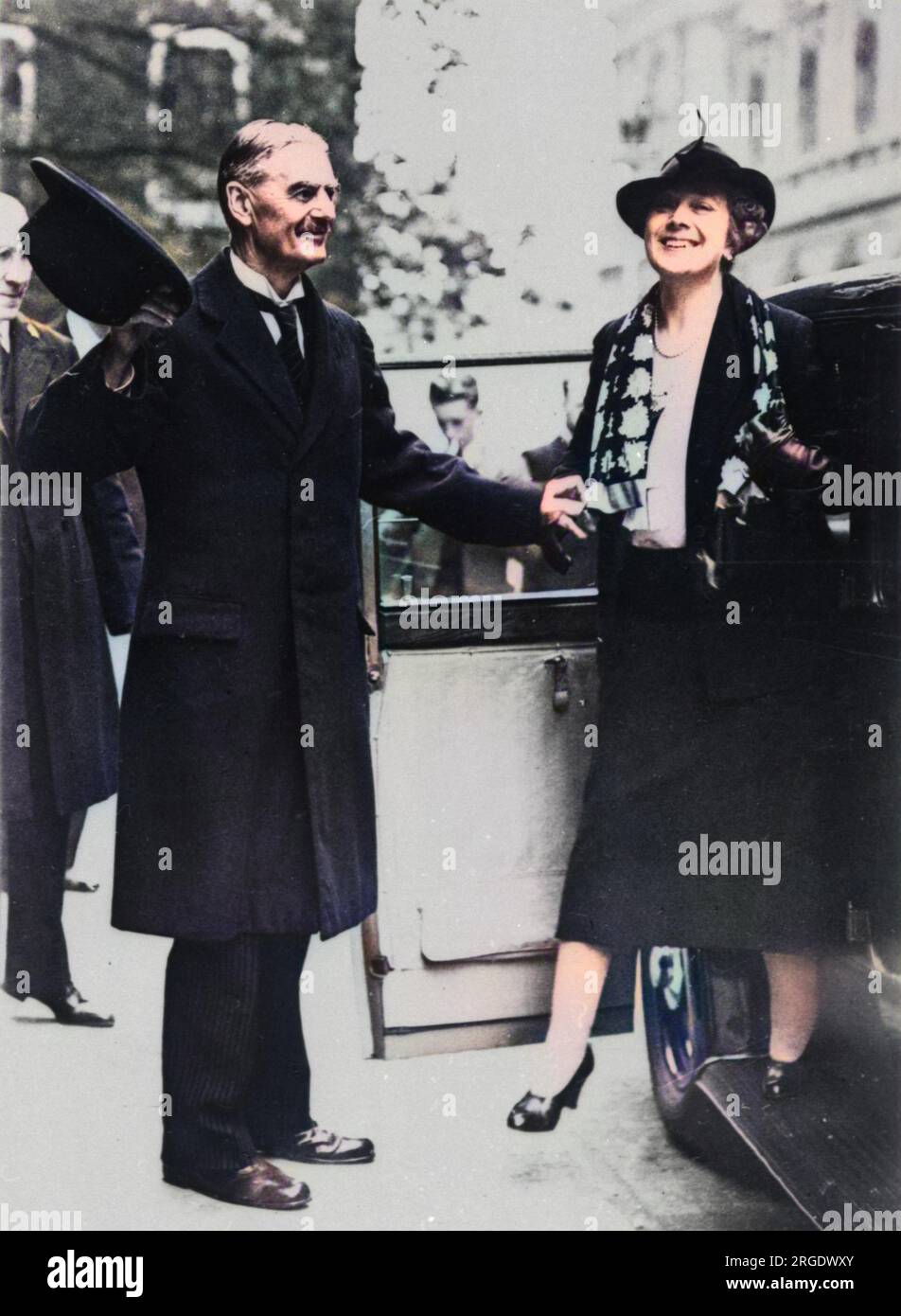 Neville Chamberlain helping his wife out of a car. British Prime Minister. Stock Photo
