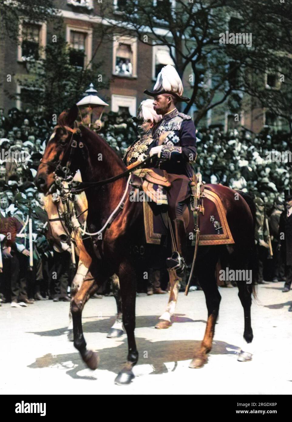 Portrait of King George V riding a horse in front of a crowd. Stock Photo