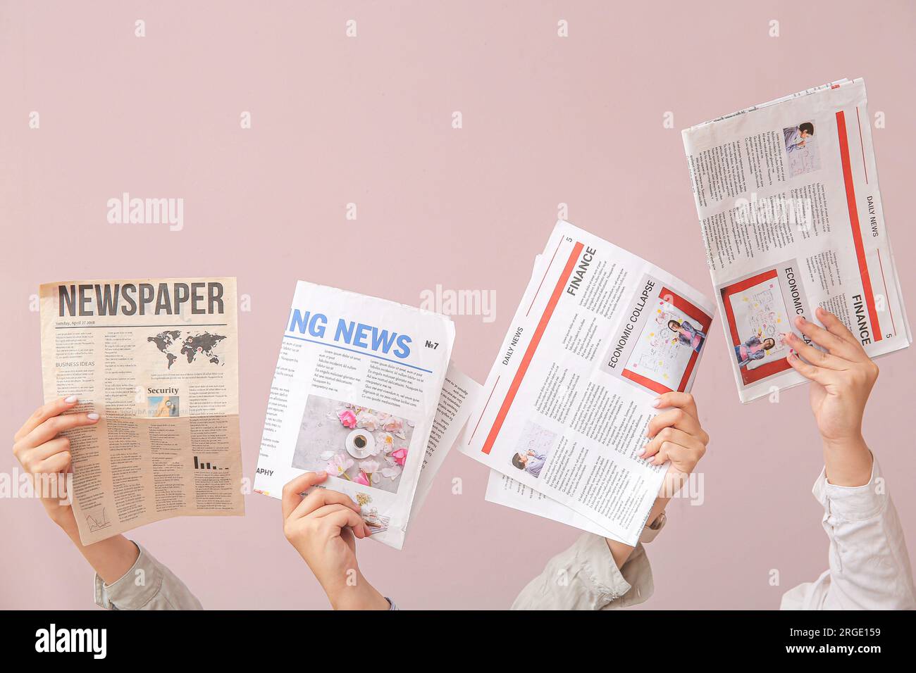 Female hands with different newspapers on color background Stock Photo