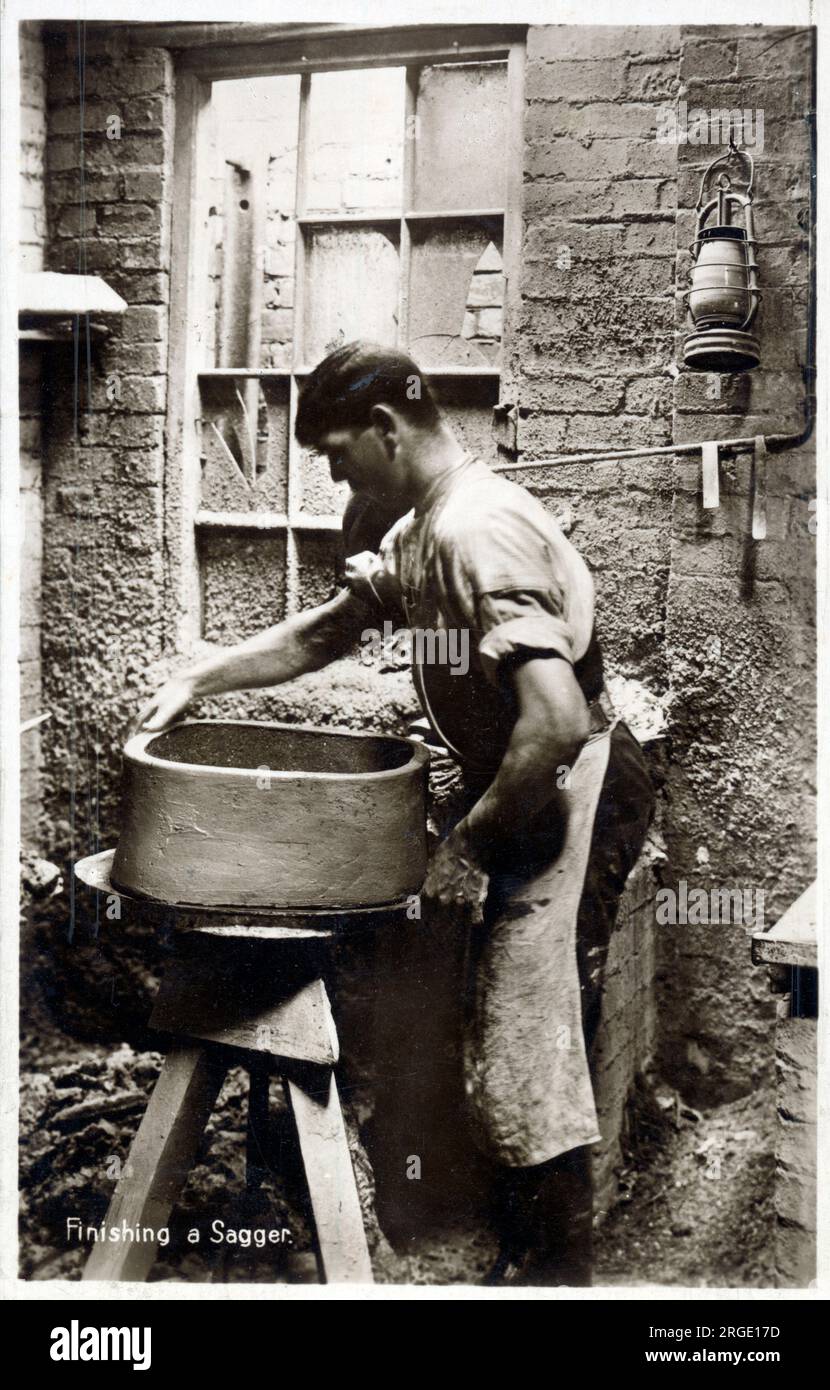 Pottery StokeonTrent Finishing a Saggar (a clay casing for firing