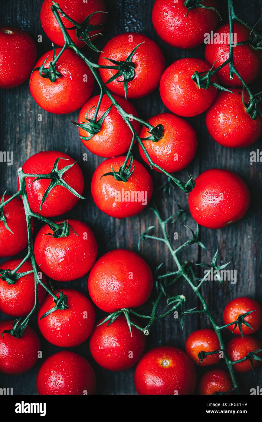 Red cherry tomatoeson a wooden background Stock Photo - Alamy