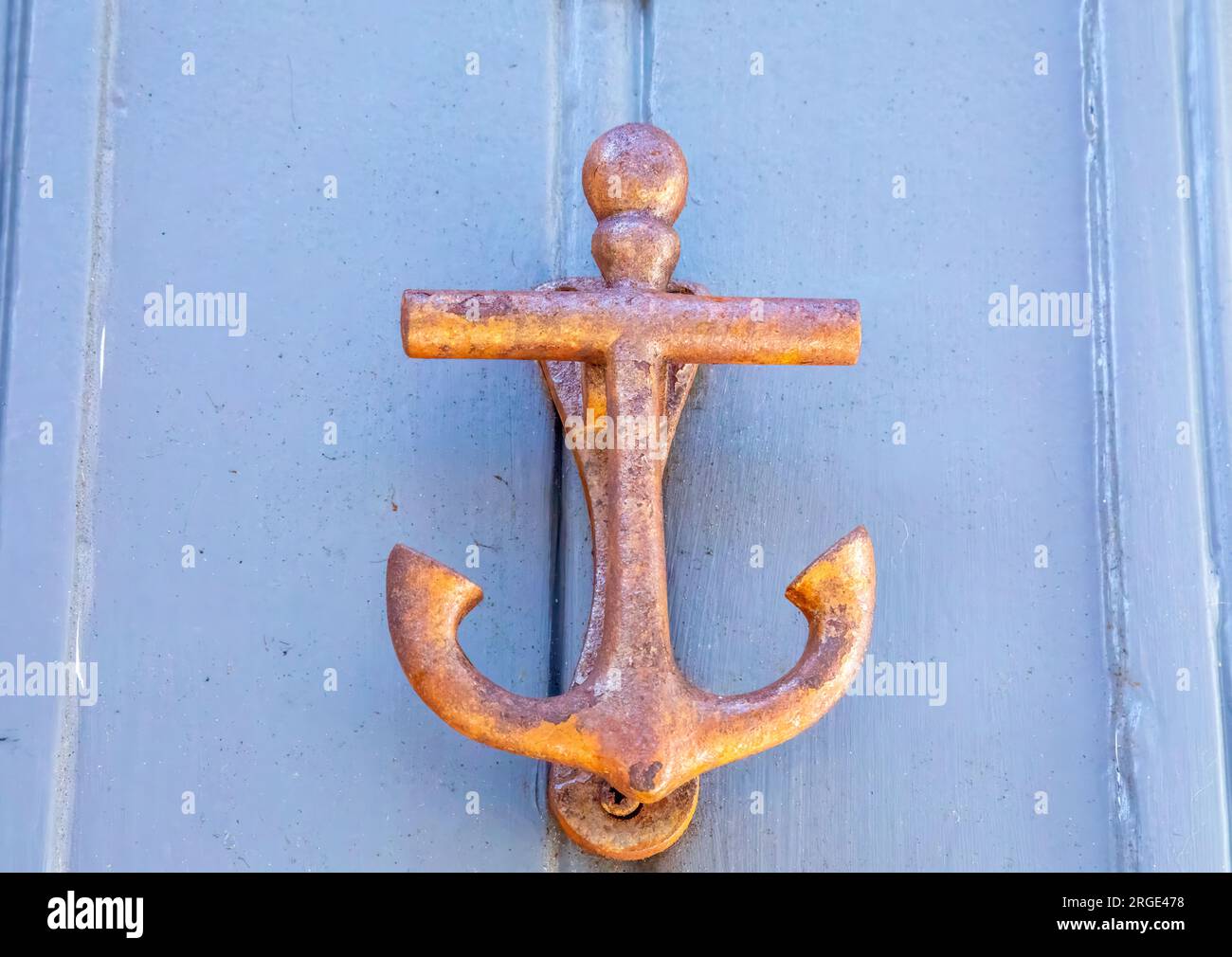 Nautical themed brass door kknocker of an anchor in a coastal town Stock Photo