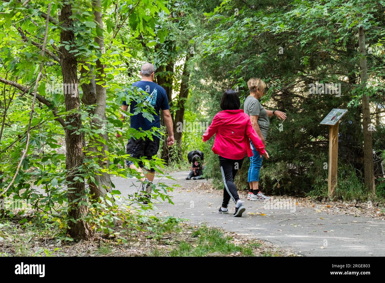 People walking on a nature & exercise trail in Sedgwick County Park, Wichita, Kansas, USA. Stock Photo