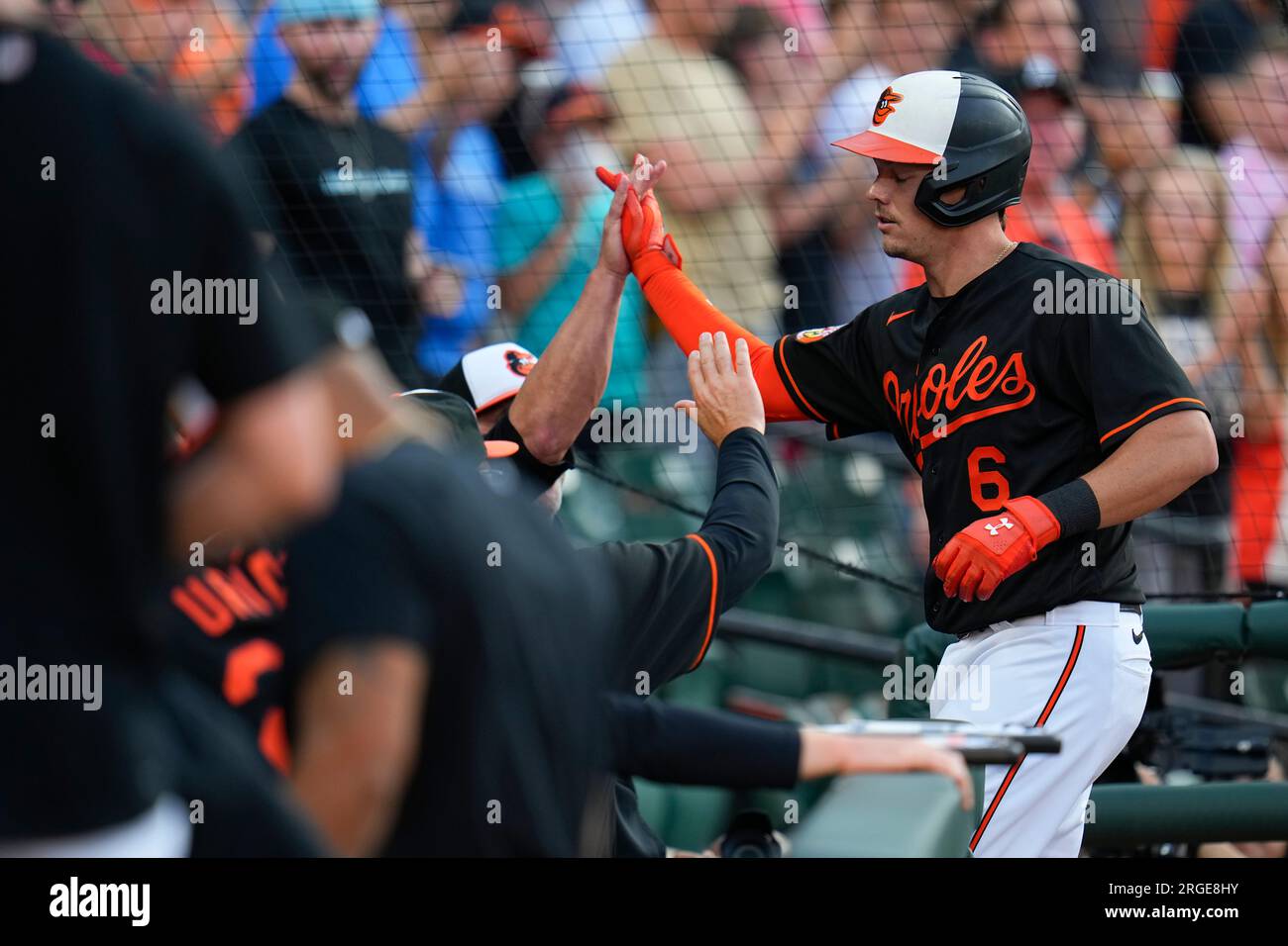 Ryan Mountcastle of the Baltimore Orioles laughs after swinging at