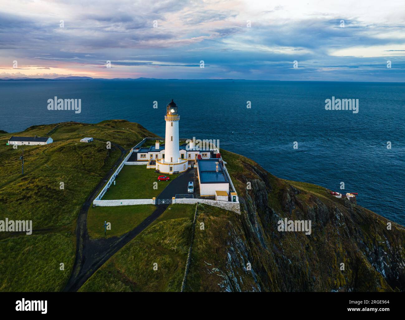 Sunset over Mull of Galloway Lighthouse from a drone, Mainland Scotland, UK Stock Photo