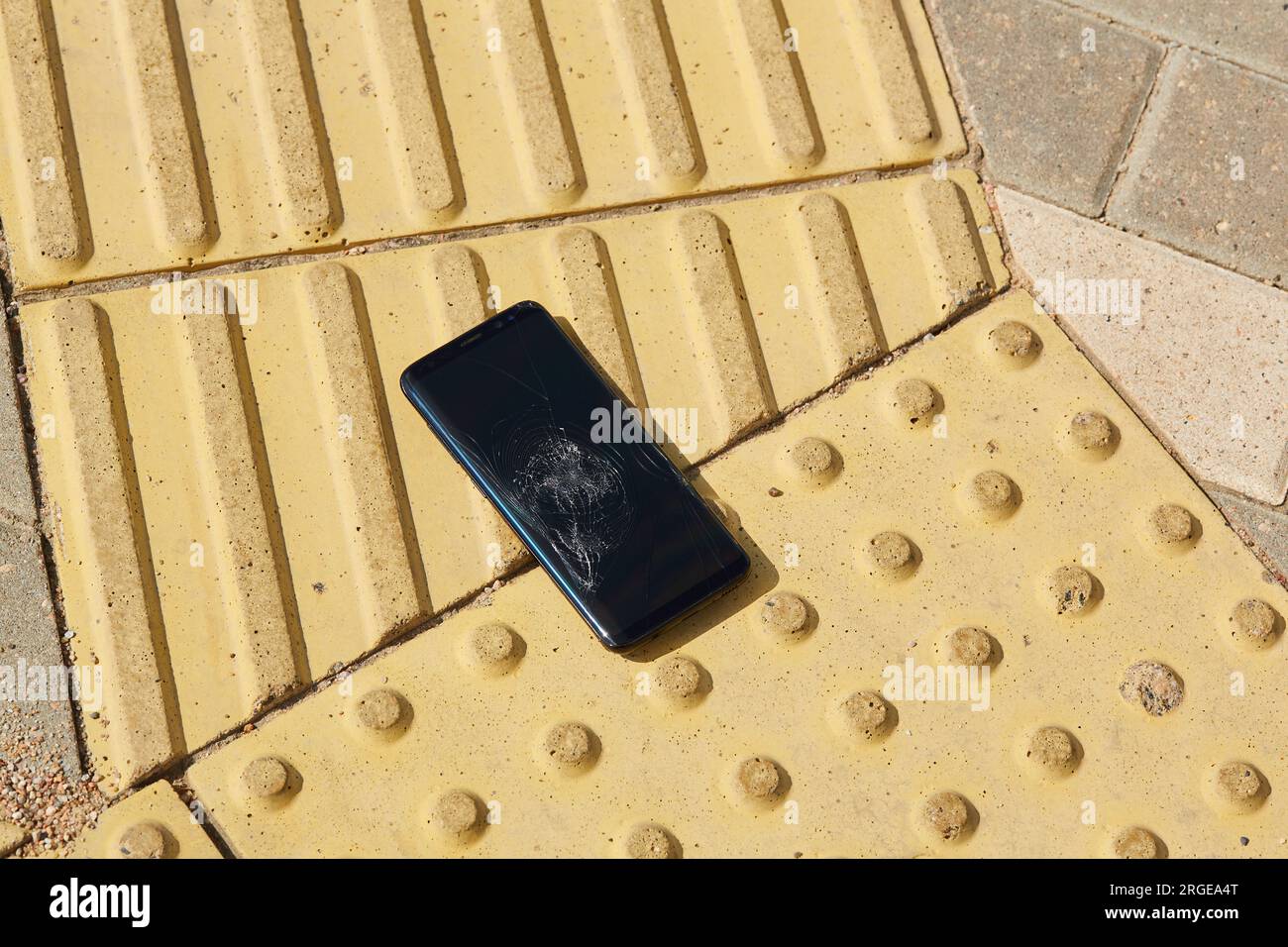 mobile phone fell and crashed on sidewalk. Smartphone with a broken