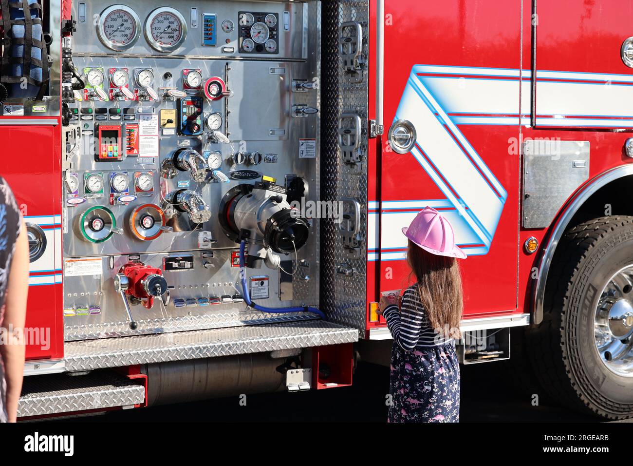 Little girl looking at a fire truck Stock Photo