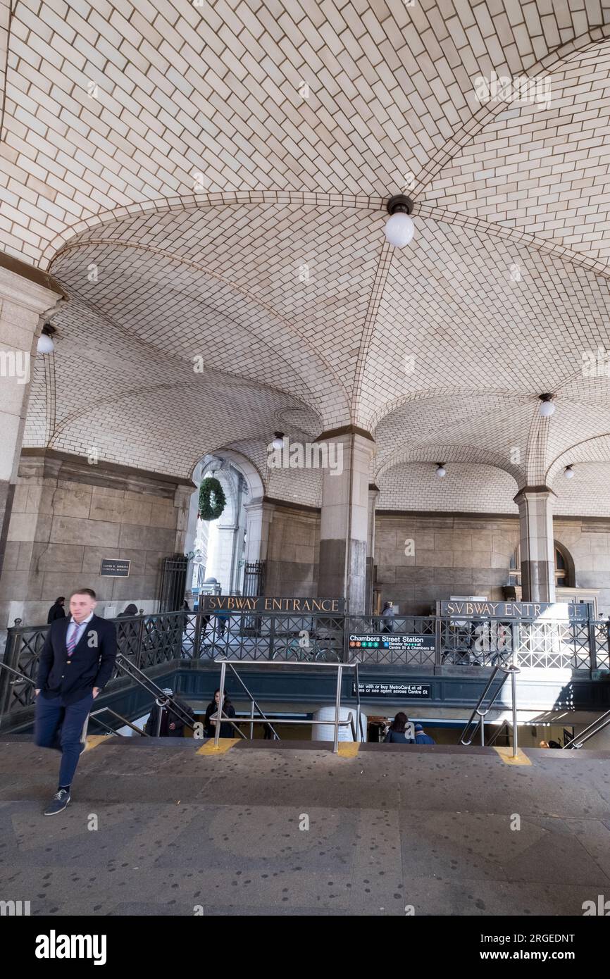 Manhattan, NY, USA - December 11h, 2018: Subway exit from Chambers Street station, with some people passing Stock Photo