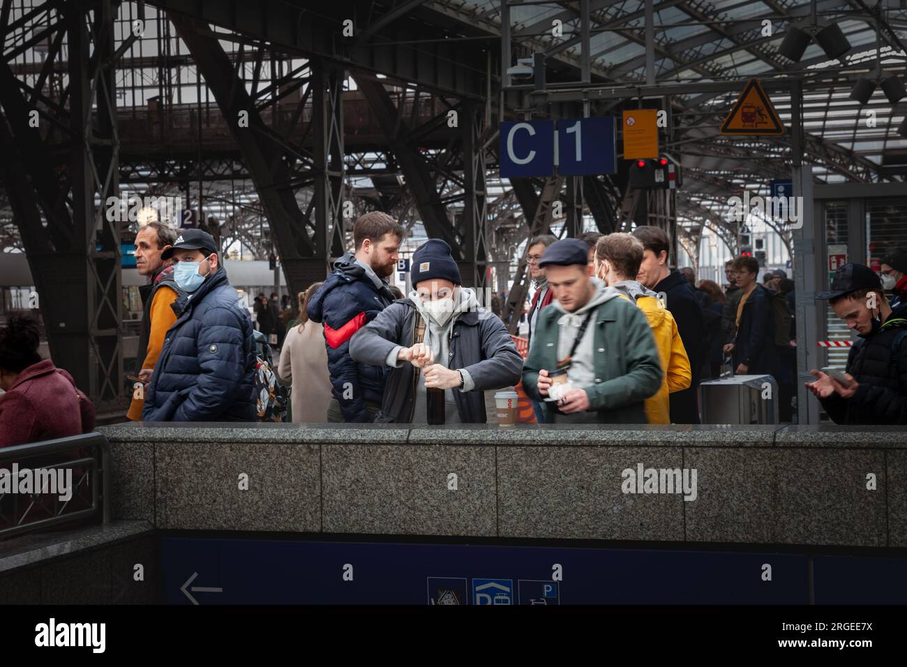 Picture of men waiting for a train on the platforms of Koln