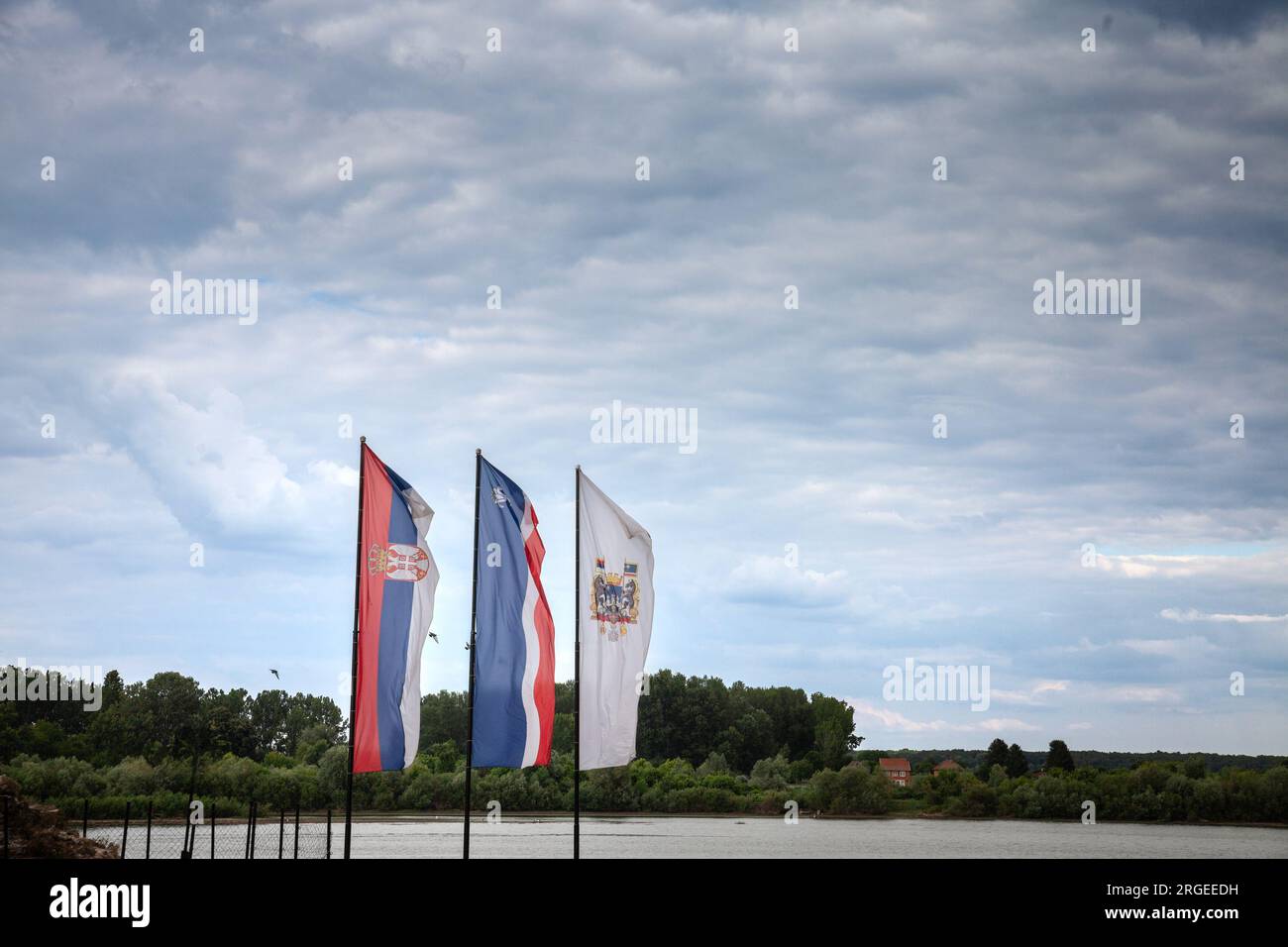 Picture of the Sabac flag and the flag of serbia during a cloudy afternoon in Sabac, Serbia. Šabac is a city and the administrative centre of the Mačv Stock Photo