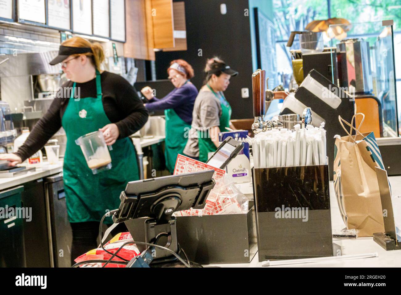 Charlotte North Carolina,Starbucks Coffee,baristas behind counter,woman women lady female,adult,residents,inside interior indoors,employee worker work Stock Photo
