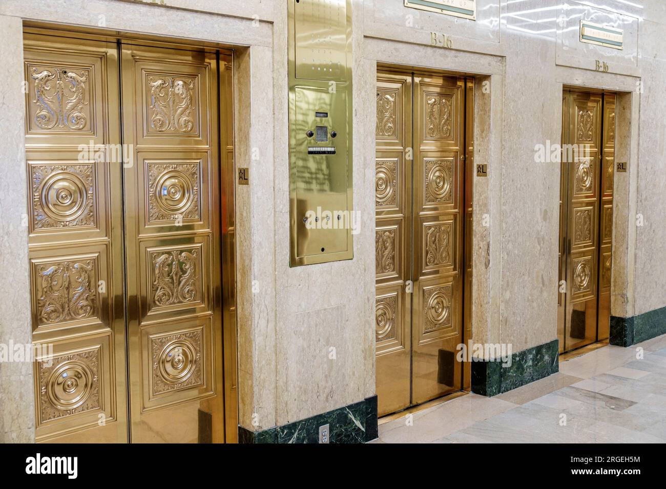 Charlotte North Carolina,South Tryon Street,The Johnston office Building,Neo classical design gold colored doors elevators lobby,inside interior indoo Stock Photo