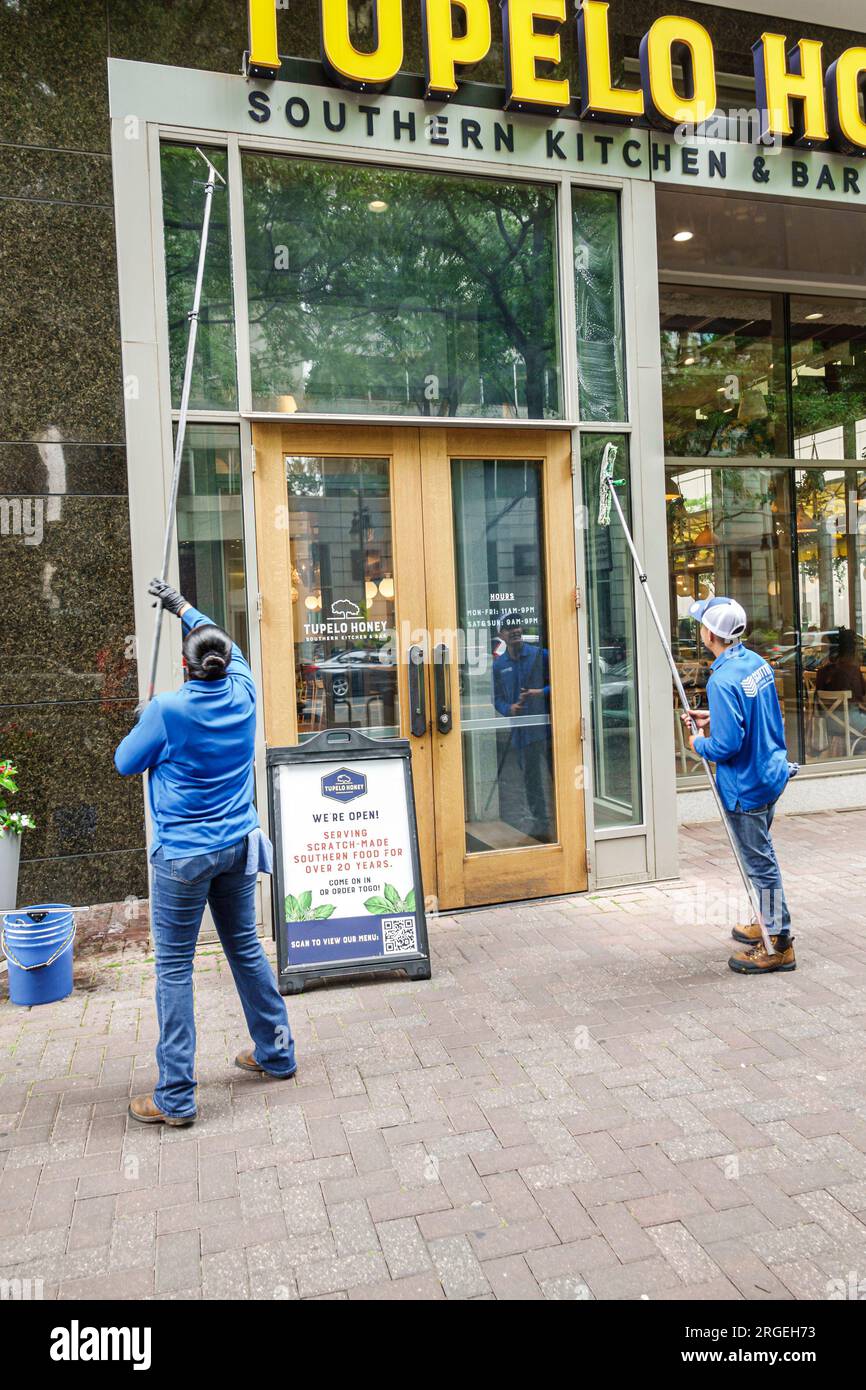 Charlotte North Carolina,window washers washing long cleaning pole wipers,Hispanic Latin Latino